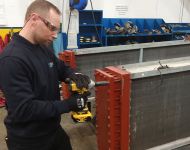 aftermarket engineer removing header at Sterling TT's factory