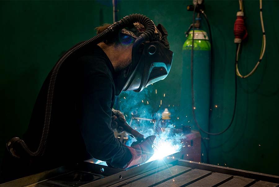 Employee welding heat exchanger at Sterling Thermal Technology's factory in the UK