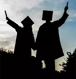 photo of two graduates, female and male