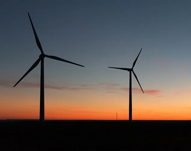 photo of wind turbines at sunset