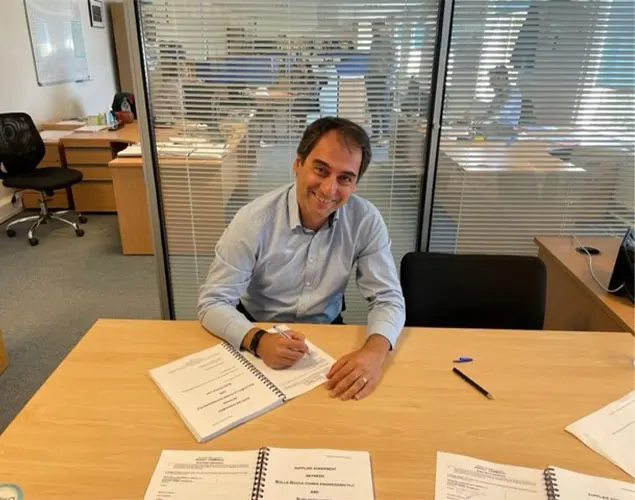 Emrah Gozturk signing the multimillion contract that Sterling Thermal Technology won