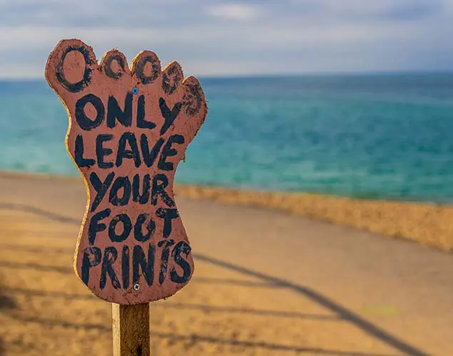 sustainability concept illustrated by a foot shape post carrying the words only leave your foot prints