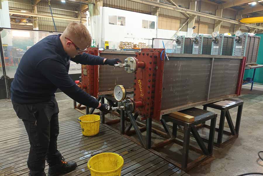 aftersales engineer performing pressure test at Sterling Thermal Technology's factory