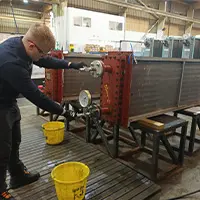 aftermarket engineer performing a pressure test in Sterling Thermal Technology's factory