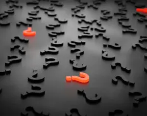 red and black question marks on grey/black background
