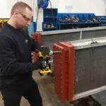 aftermarket engineer removing header in Sterling TT's factory