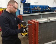 aftermarket engineer removing header at Sterling TT's factory